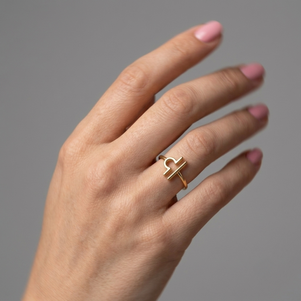 handmodel wearing golden 14k zodiac libra ring