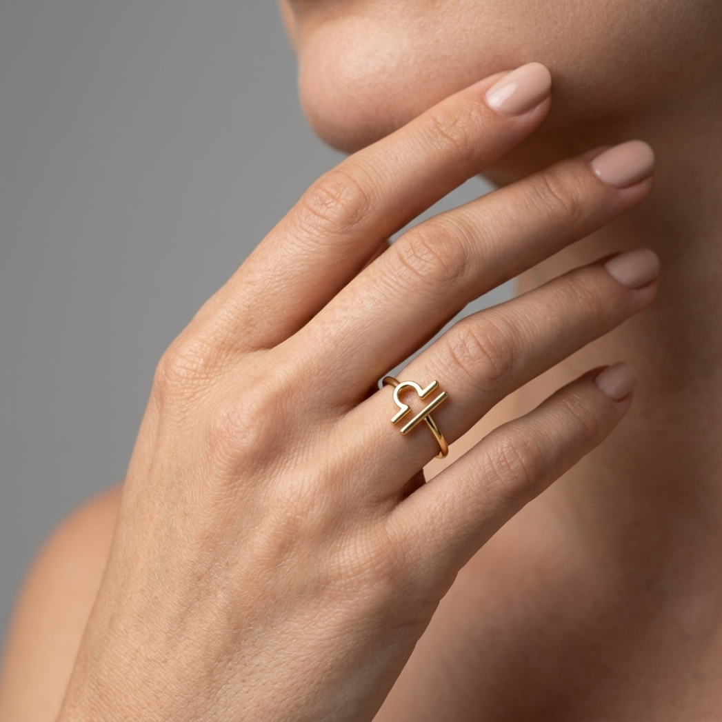 14k gold Libra ring model lifestyle detail shot, grey background