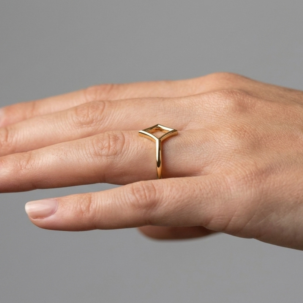 L'As de Carreau ring close-up showing the diamond suit silhouette in gold