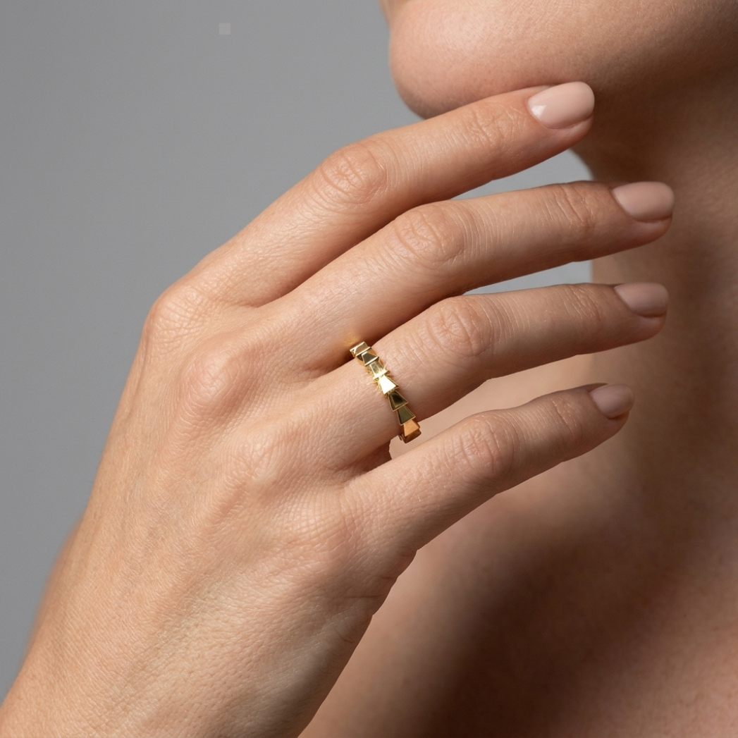 Gold snake-skin textured ring worn on hand, lifestyle shot