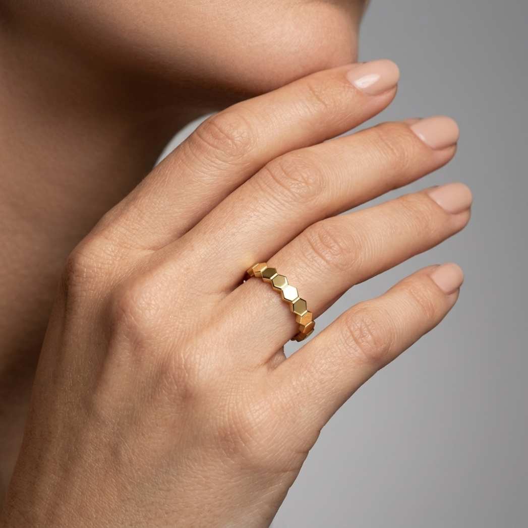 Maya gold hexagon ring, close-up front view model hand
