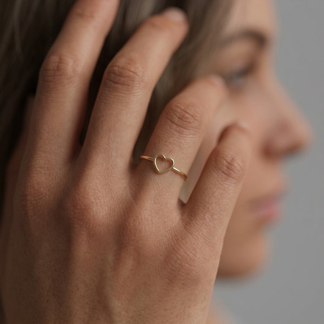Cœur d'Or gold heart ring worn on hand, close-up