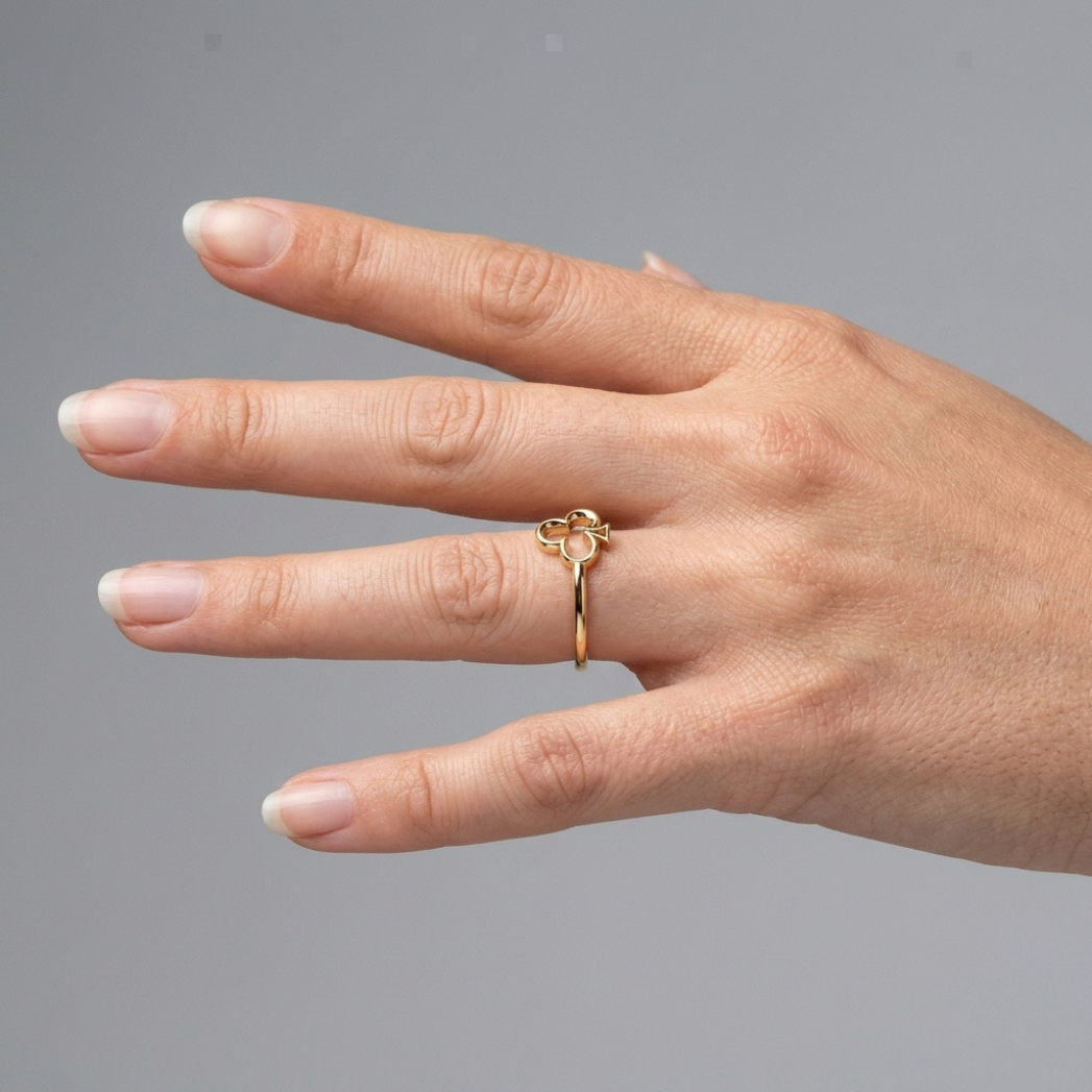 Queen of Clubs gold ring worn on hand, lifestyle shot