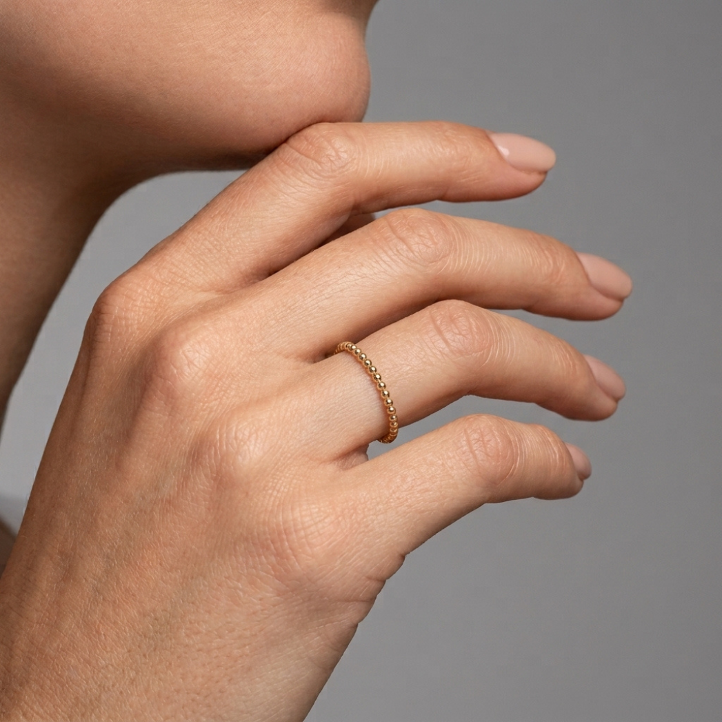 Parlé gold bead stacking ring, hand close up model