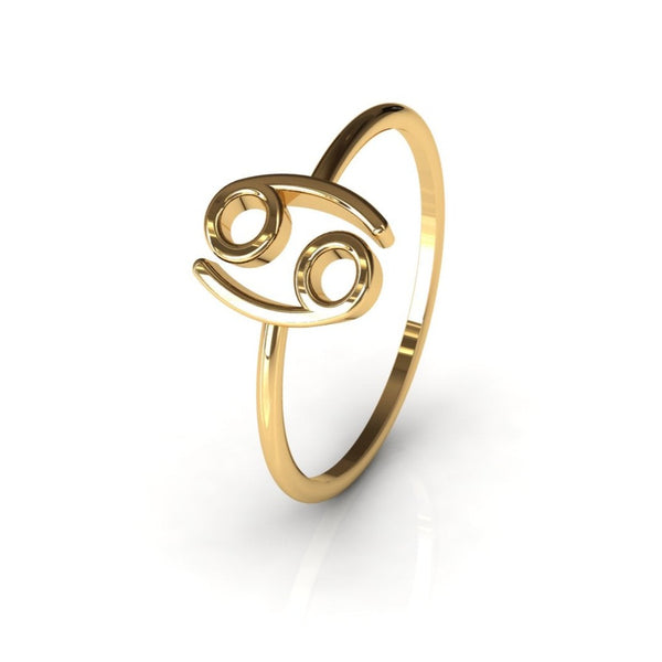 Cancer zodiac gold ring on warm white studio background, front view
