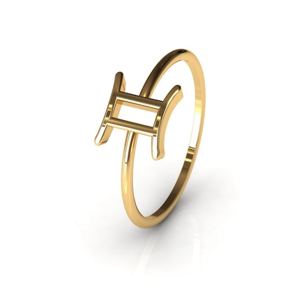 Gemini zodiac gold ring on warm grey studio background, front view
