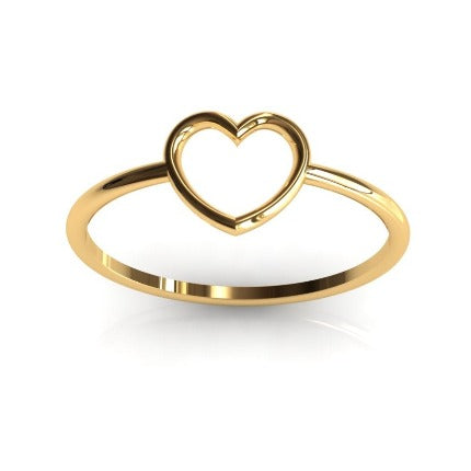 Gold heart motif ring worn on hand, natural light