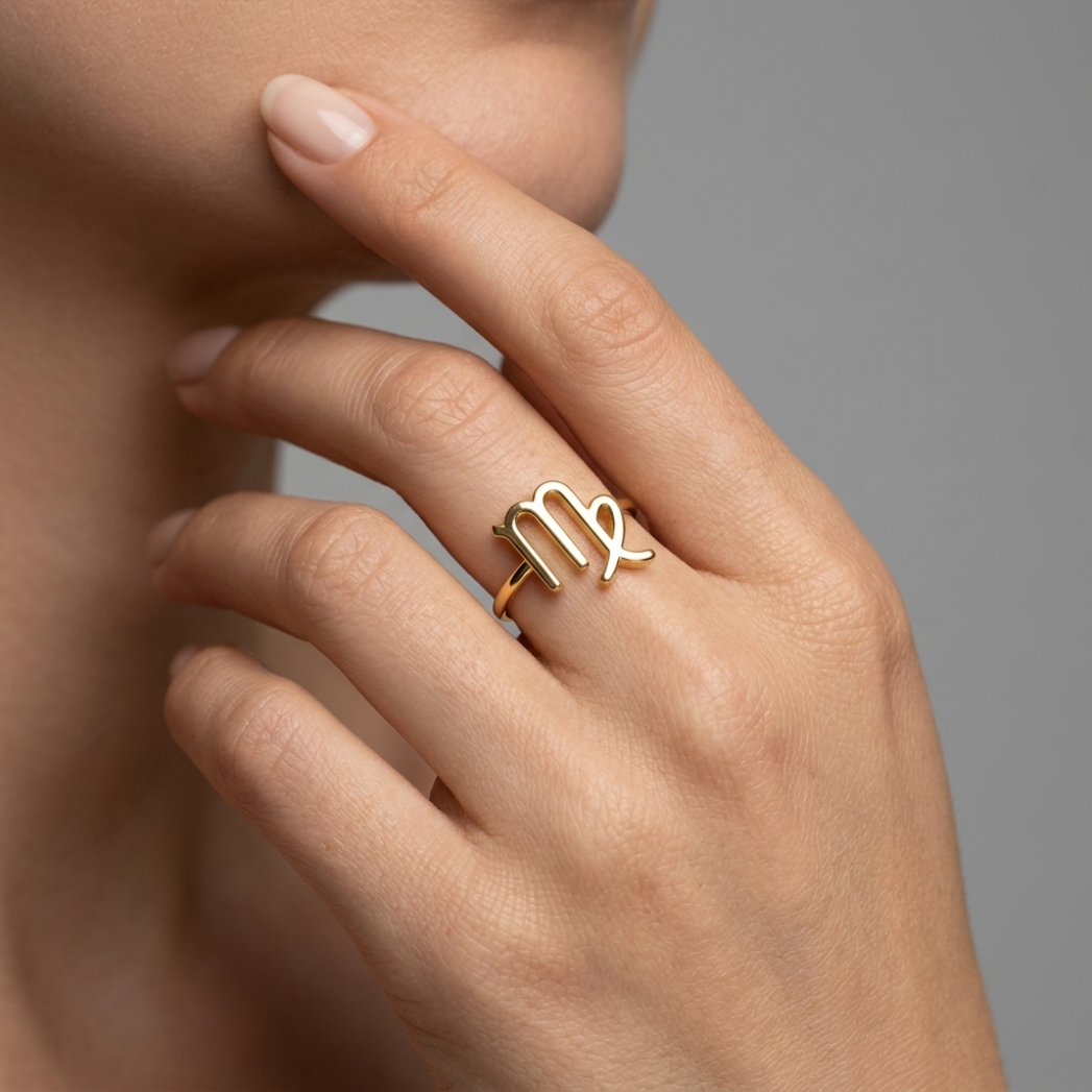 14k gold Aries ring detail shot, studio grey background