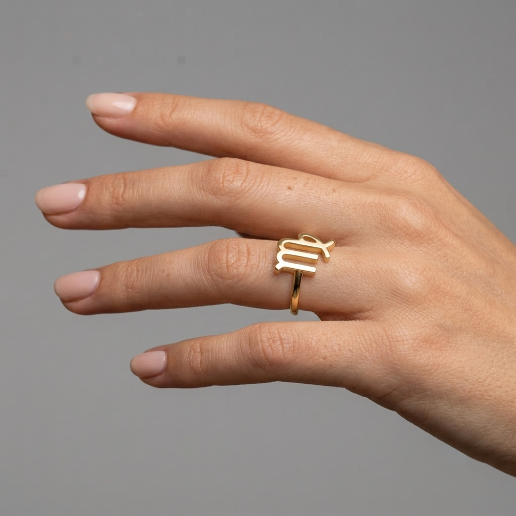 Aries zodiac gold ring close-up showing ram symbol engraving