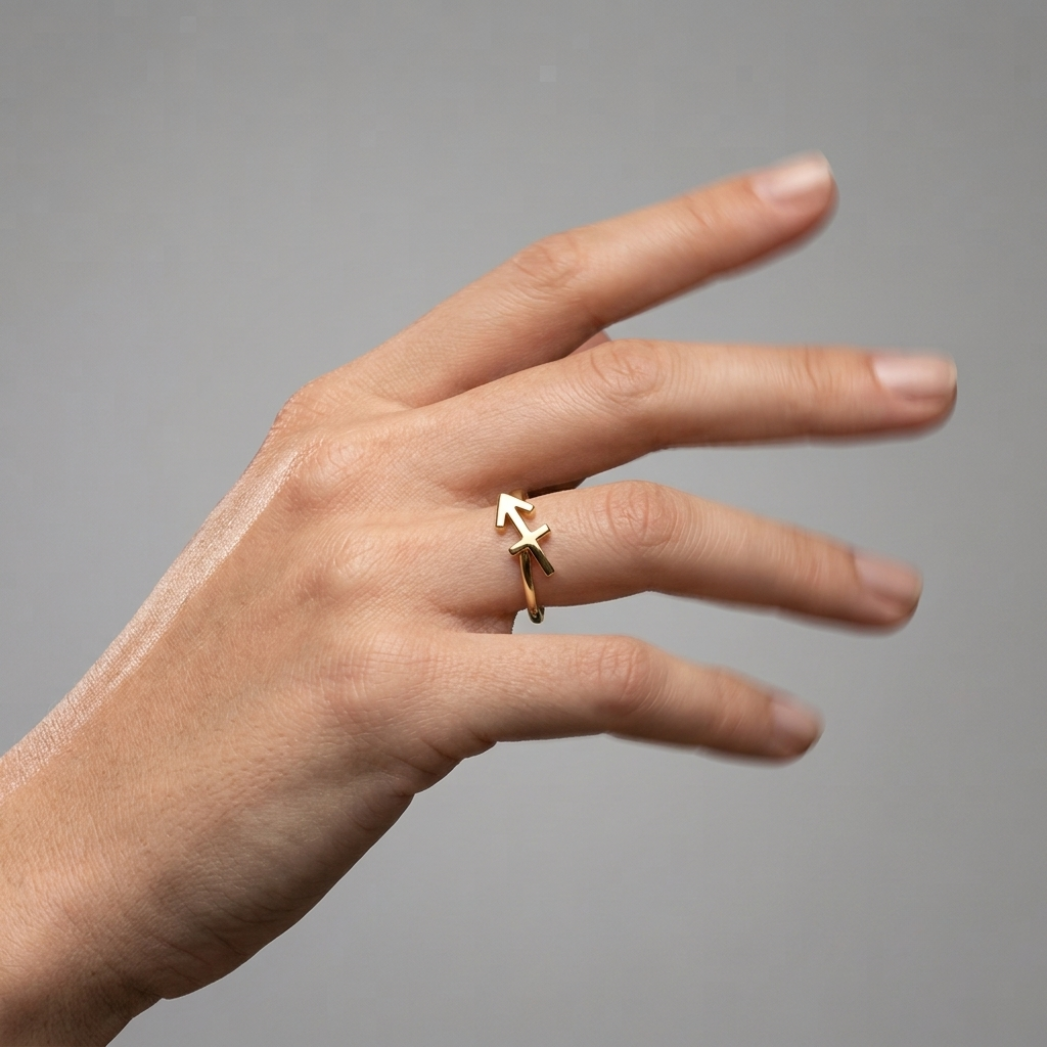 blurred handshot Solid gold Sagittarius ring detail shot - archer zodiac symbol
