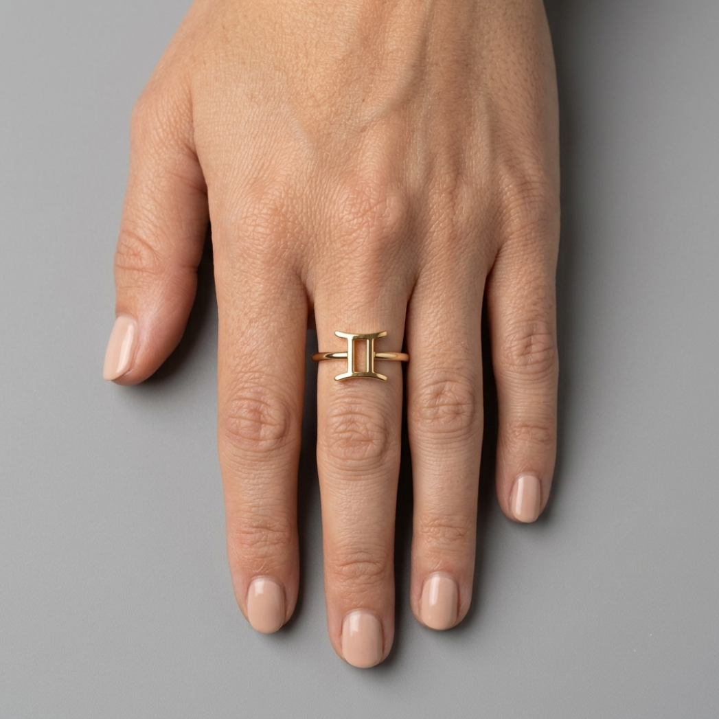 Gemini gold ring worn by model, lifestyle shot with natural hand pose

