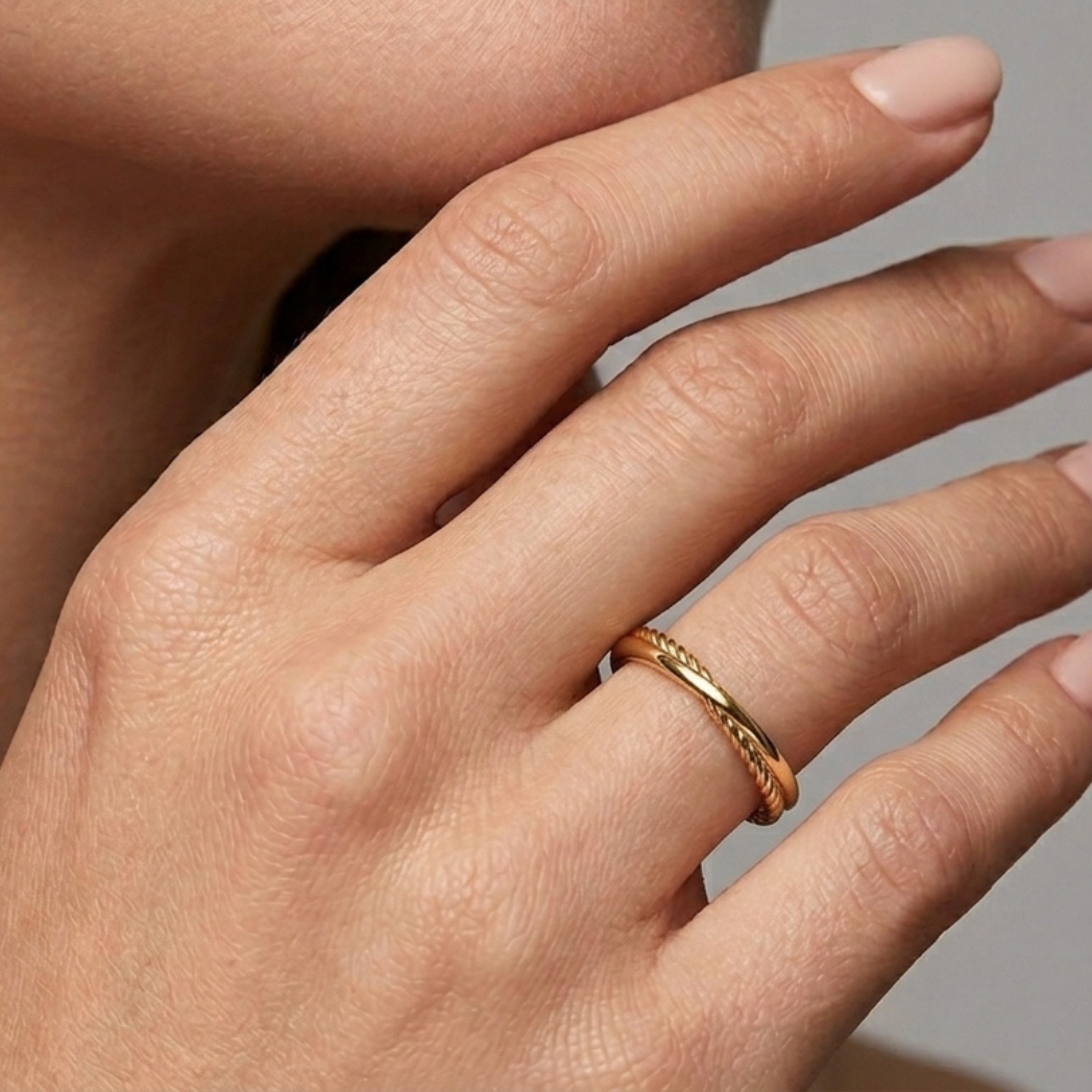 14K gold entwined ring styled on hand, natural light