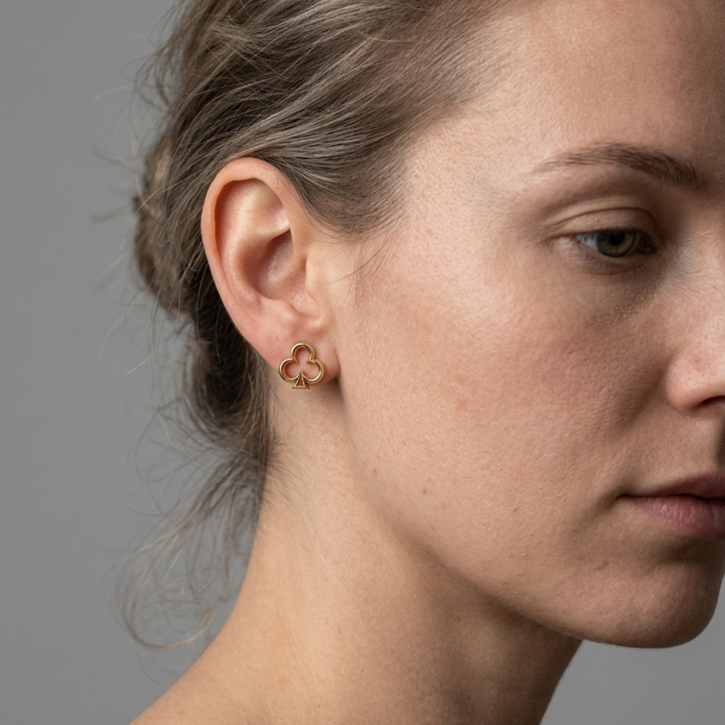 model with 14k gold clubs-suit stud earrings, close-up view