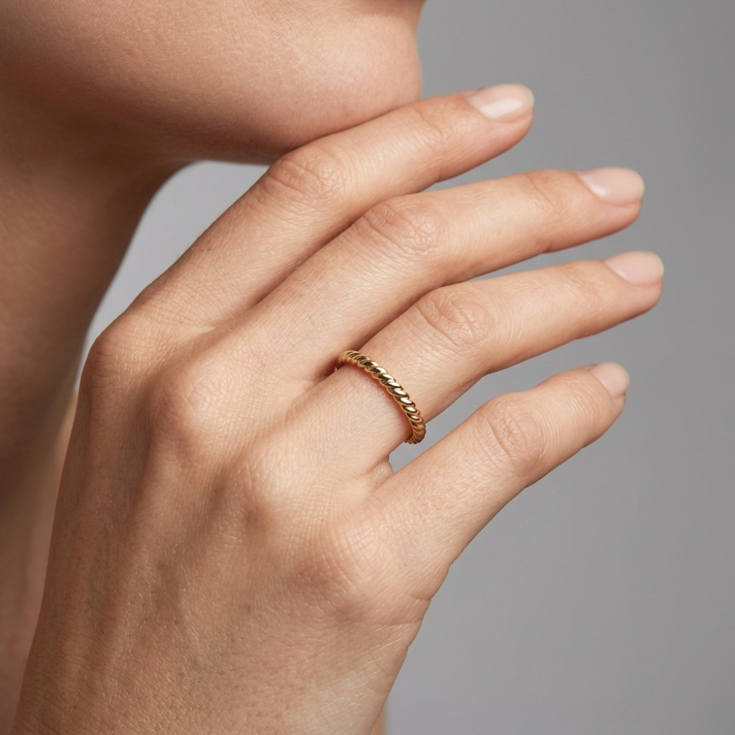 Gold rope-knot open ring, close-up front view with model