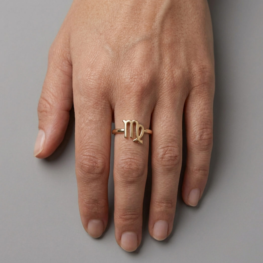 Female hand with gold Scorpio Ring – elegant gold zodiac Scorpio ring from the Starsky XII jewelry collection
